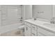 Well-lit bathroom showcasing double sinks with modern fixtures, a tiled floor, and a bathtub with shower at 162 Holsworthy Dr, Mooresville, NC 28115