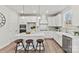 Bright kitchen features white cabinets, stainless steel appliances, large island with seating and decorative pendant lights at 162 Holsworthy Dr, Mooresville, NC 28115