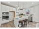 Modern kitchen featuring white cabinets, a large island, stainless steel appliances, and stylish pendant lighting at 162 Holsworthy Dr, Mooresville, NC 28115