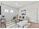 Cozy living room featuring a plush sofa, stylish coffee table, bench, neutral decor, and ample natural light at 162 Holsworthy Dr, Mooresville, NC 28115