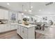 Open concept living space with a kitchen island and adjacent dining area, filled with light at 162 Holsworthy Dr, Mooresville, NC 28115