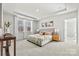 Bright main bedroom featuring a tray ceiling, carpet floors, large windows and an ensuite bathroom at 162 Holsworthy Dr, Mooresville, NC 28115