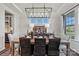 Nicely appointed dining room with modern chandelier, large windows and decorative table setting for elegant entertaining at 164 Holsworthy Dr, Mooresville, NC 28115