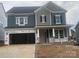 Two-story home with blue and gray siding, a large garage, and a covered front porch at 164 Holsworthy Dr, Mooresville, NC 28115