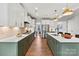 Spacious kitchen featuring stainless appliances, light countertops, green cabinets, and modern pendant lighting at 164 Holsworthy Dr, Mooresville, NC 28115