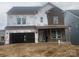 Two-story house with brick and siding exterior, covered front porch, and two car garage at 166 Holsworthy Dr, Mooresville, NC 28115