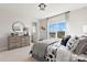 Well-lit bedroom featuring sports themed bedding, a dresser, and a view into an adjoining bathroom at 173 Holsworthy Dr, Mooresville, NC 28115