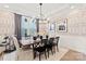 Contemporary dining space featuring patterned wallpaper, window views, and modern lighting at 173 Holsworthy Dr, Mooresville, NC 28115