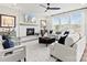 Bright living room with fireplace, large windows, ceiling fan, and modern decor at 173 Holsworthy Dr, Mooresville, NC 28115