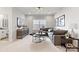 Cozy living room featuring a large gray sectional, media console, and a window with natural light at 173 Holsworthy Dr, Mooresville, NC 28115