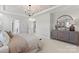 Bright main bedroom boasts tray ceiling detail, plush carpet, and easy access to the ensuite bathroom at 173 Holsworthy Dr, Mooresville, NC 28115