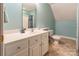 This light blue bathroom has a white vanity, a toilet, and a shower with a patterned blue curtain at 1847 Bertha Knight Rd, Lancaster, SC 29720