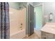 A shower-tub combo is inside a light blue bathroom with a shower door, faucet, and shower head at 1847 Bertha Knight Rd, Lancaster, SC 29720