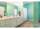 A bright bathroom features a long white vanity with countertop and a shower with a white curtain at 1847 Bertha Knight Rd, Lancaster, SC 29720