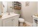 A simple bathroom features a sink with a vanity, a toilet, and some decor at 1847 Bertha Knight Rd, Lancaster, SC 29720