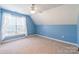 A blue carpeted bedroom features a ceiling fan and a window with sheer white curtains at 1847 Bertha Knight Rd, Lancaster, SC 29720