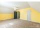 A carpeted yellow bedroom has a ceiling fan and access to the closet and another room at 1847 Bertha Knight Rd, Lancaster, SC 29720