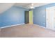 This is a blue carpeted bedroom with a ceiling fan and access to two closets at 1847 Bertha Knight Rd, Lancaster, SC 29720
