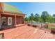 An expansive deck with railing overlooks a pool and the surrounding landscape at 1847 Bertha Knight Rd, Lancaster, SC 29720