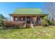 Charming brick home featuring a metal roof and inviting front porch with mature landscaping at 1847 Bertha Knight Rd, Lancaster, SC 29720