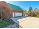 A brick home features an attached garage and a paved driveway for ample parking at 1847 Bertha Knight Rd, Lancaster, SC 29720