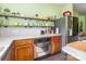 Kitchen with stainless steel oven, white countertops, open shelving, and wooden cabinets at 1847 Bertha Knight Rd, Lancaster, SC 29720