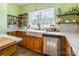 Bright kitchen featuring a farmhouse sink, open shelving, and stainless steel appliances at 1847 Bertha Knight Rd, Lancaster, SC 29720
