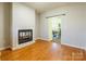 Bright living room with hardwood floors, a fireplace, and a view to the dining room at 1847 Bertha Knight Rd, Lancaster, SC 29720