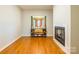 Bright living room with hardwood floors, a decorative table, and fireplace at 1847 Bertha Knight Rd, Lancaster, SC 29720