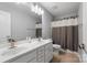 Clean, bright bathroom with double sink vanity, large mirror and shower-tub combination at 1875 Loggerhead Dr, Lancaster, SC 29720