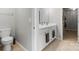 Bright bathroom featuring double sinks, white cabinets, and a modern toilet at 1875 Loggerhead Dr, Lancaster, SC 29720
