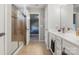 Modern bathroom with dual sinks, tile flooring, glass shower and open doorway at 1875 Loggerhead Dr, Lancaster, SC 29720
