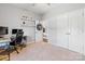 Second bedroom with neutral tones featuring a desk area, plush carpet, and closet at 1875 Loggerhead Dr, Lancaster, SC 29720
