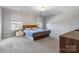 Well-lit bedroom with a comfortable bed, side tables, and soft carpet at 1875 Loggerhead Dr, Lancaster, SC 29720