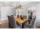 Elegant dining room with modern light fixture and view of the kitchen, features durable wood-look floors at 1875 Loggerhead Dr, Lancaster, SC 29720