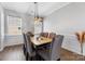 Elegant dining room features modern lighting, gray chairs, and durable wood-look floors at 1875 Loggerhead Dr, Lancaster, SC 29720