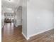 Inviting hallway features a decorative archway, durable wood floors, and neutral gray wall paint at 1875 Loggerhead Dr, Lancaster, SC 29720