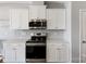 Well-appointed kitchen with stainless steel appliances, white cabinets, and quartz countertops at 1875 Loggerhead Dr, Lancaster, SC 29720