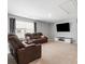 Large living room with plush reclining sofas, big screen tv, and neutral decor at 1875 Loggerhead Dr, Lancaster, SC 29720