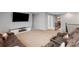 Open living room with plush sofas, modern entertainment center, and staircase access at 1875 Loggerhead Dr, Lancaster, SC 29720