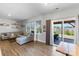 Bright living room with a comfortable sectional sofa, wood floors, and sliding glass doors to outdoor space at 1875 Loggerhead Dr, Lancaster, SC 29720