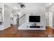 Inviting living area with hardwood floors and staircase, featuring a modern entertainment center at 1875 Loggerhead Dr, Lancaster, SC 29720