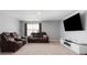 Spacious living room with plush sofas, large window, and modern entertainment center at 1875 Loggerhead Dr, Lancaster, SC 29720