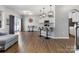 Open-concept living space features modern lighting, breakfast bar, and access to outdoor area at 1875 Loggerhead Dr, Lancaster, SC 29720