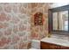 Charming powder room featuring decorative wallpaper, a framed mirror, and a classic vanity at 2301 Lynbridge Dr, Charlotte, NC 28270