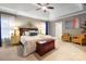 Spacious main bedroom featuring a tray ceiling, sitting area, white carpet, and great natural light at 2305 Flintwood Ln, Charlotte, NC 28226