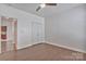 Spacious bedroom with hardwood floors, a ceiling fan, and a double door closet at 242 Tradition Way, Rock Hill, SC 29732