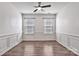 Living room featuring hardwood floors, wainscoting, and natural light from two windows at 242 Tradition Way, Rock Hill, SC 29732