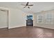 Spacious living room featuring a fireplace with TV, ceiling fan, and two large windows at 242 Tradition Way, Rock Hill, SC 29732