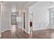 View of the living room with hardwood floors, neutral paint, and a glimpse of the kitchen at 242 Tradition Way, Rock Hill, SC 29732